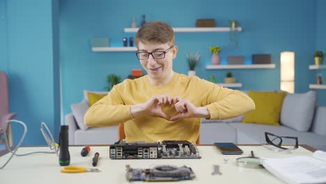 Tech-savvy-teenager-makes-a-technological-heart-sign-at-the-camera.