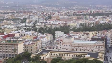 panoramic view of the city of melilla, spain, on a cloudy day. the static camera captures the variety of urban architecture, rooftops, and the landscape in general