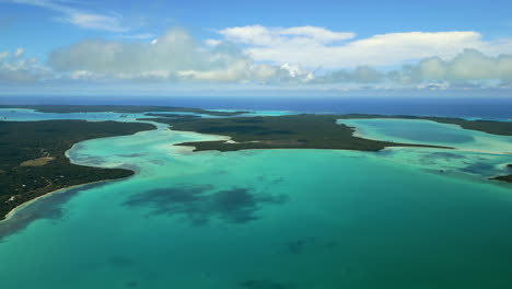 Aerial-panning-shot-above-Saintt-Maurice-bay-in-isle-of-Pines,-clouds-shadows-moving