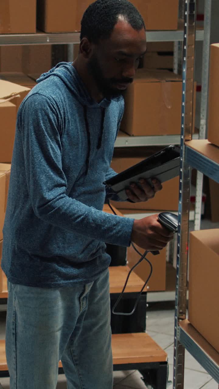 Vertical video: Small business owner scanning bar code on carton boxes