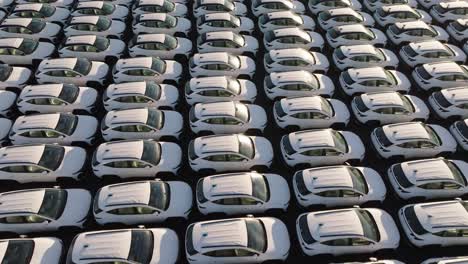 flying over countless mass production vehicles parked near each other,