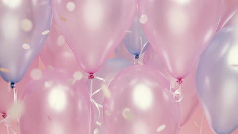 confetti falling  in slow motion pink and blue balloons background - red epic dragon