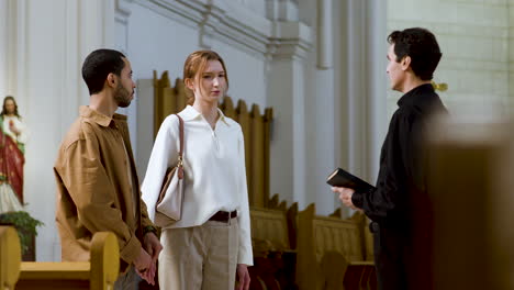 three people talking indoors