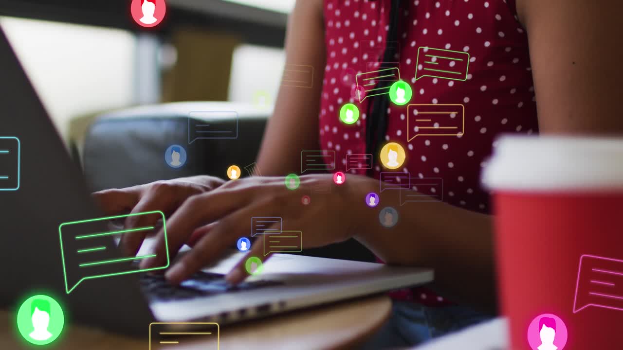 Animation of media icons over african american businesswoman using laptop