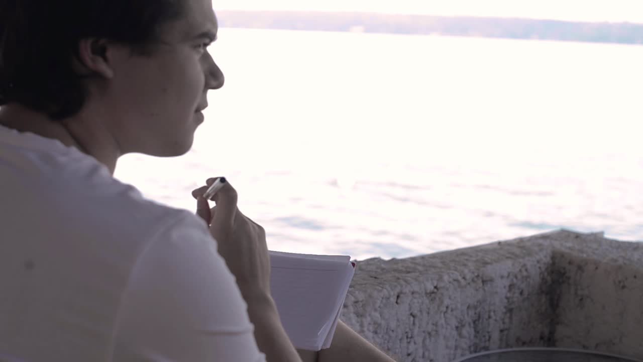 Young latin man writing his new year resolutions on the morning of January 1st ready to start the year