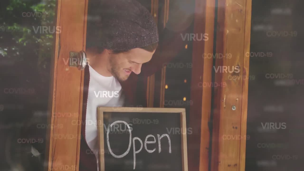 Animation of multiple Covid-19 words floating over happy Caucasian male chef