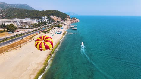 the red-yellow parachute is shading behind the boat