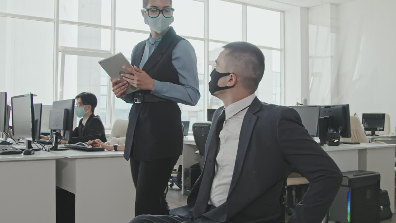 Businesswoman and Businessman in Wheelchair Wearing Face Masks in Office