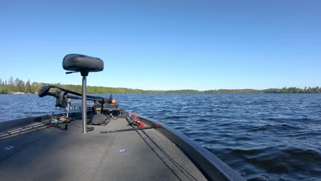 Front-end-of-bass-fishing-boat-with-a-butt-seat,-trolling-motor-and-fishing-rods