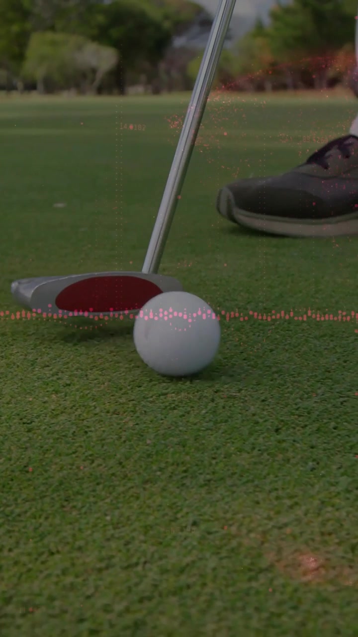Vertical video: Golfer swinging putter causing overlay guiding golf ball into cup, aiming for hole