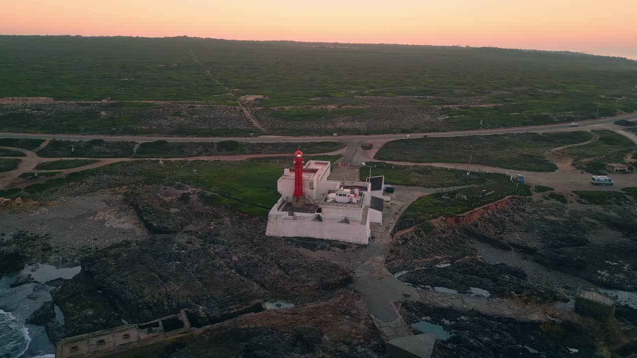 Beautiful beacon blinking coast under morning sky aerial view. Red lighthouse