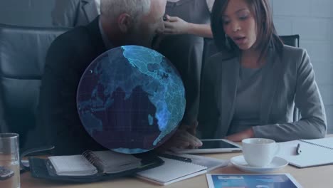 animation of blue globe over businessman and businesswoman using tablet and talking in office