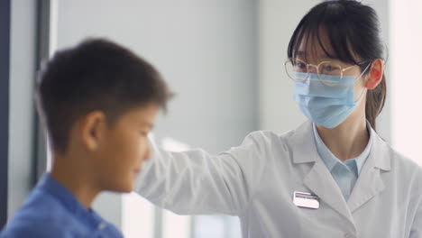 asian female doctor supporting sick kid
