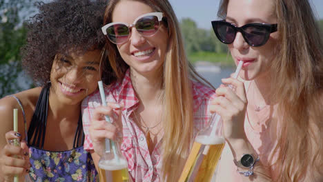 cheerful young girls having beer