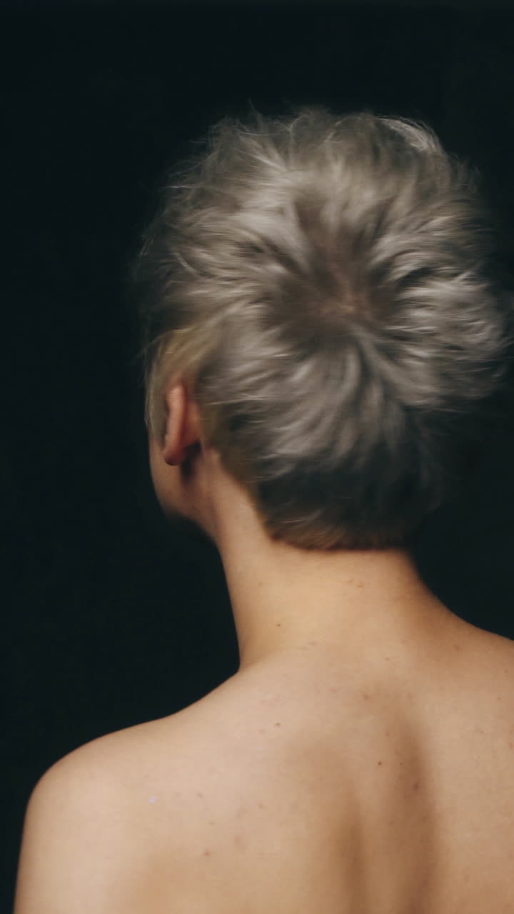 Beautiful face with professional creative make up. Beauty woman face with beautiful make-up color. Portrait shot in studio on a blaack background