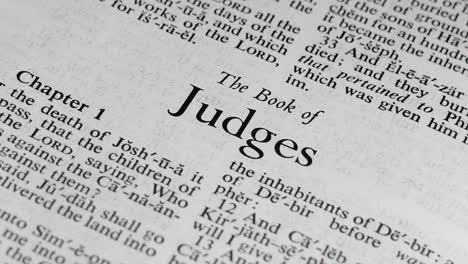 close up shot of bible turning to the book of judges