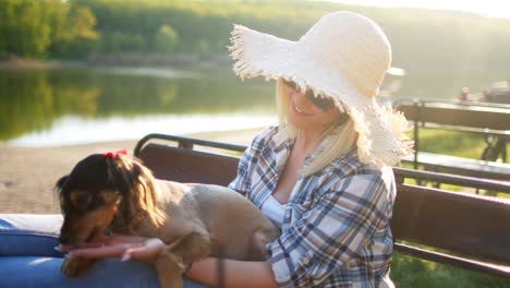 young woman relaxing on bench with her dog