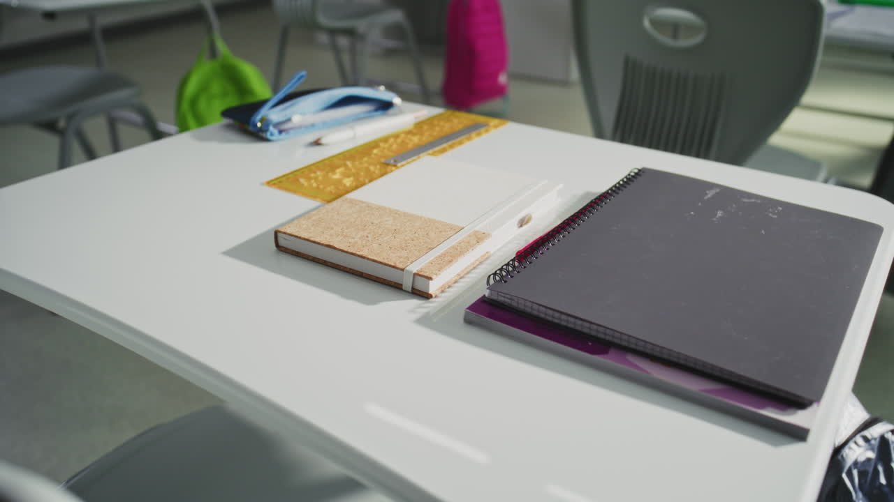 Close Up Shot of School Desk with Student School Supplies Pencil Case Pens and Pencils Notebooks