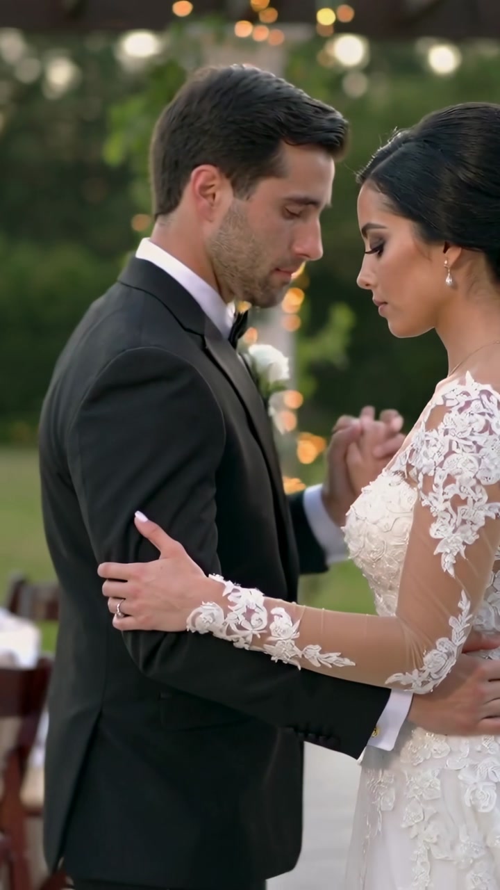 Vertical video: First dance starting, swaying bride and groom at pergola for reception, gown tuxedo