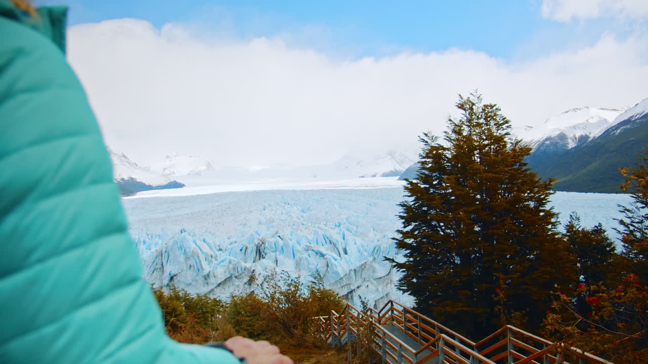 Tourist Enjoying the View of Perito Moreno near Santa Cruz, Patagonia, Argentina.Lone Female Traveler Walking at Los Glaciers National Park. Explorer Alone at the Glacier