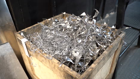 Large-wooden-box-of-metal-shavings-standing-inside-factory