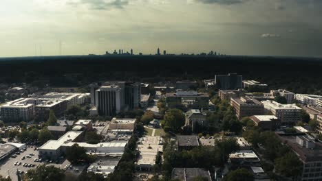 Pullback-aerial-shot-of-downtown-Decatur-Georgia-with-the-Atlanta-Skyline-in-the-background