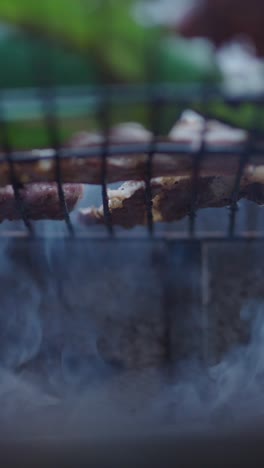 meat grilling on barbecue with smoke