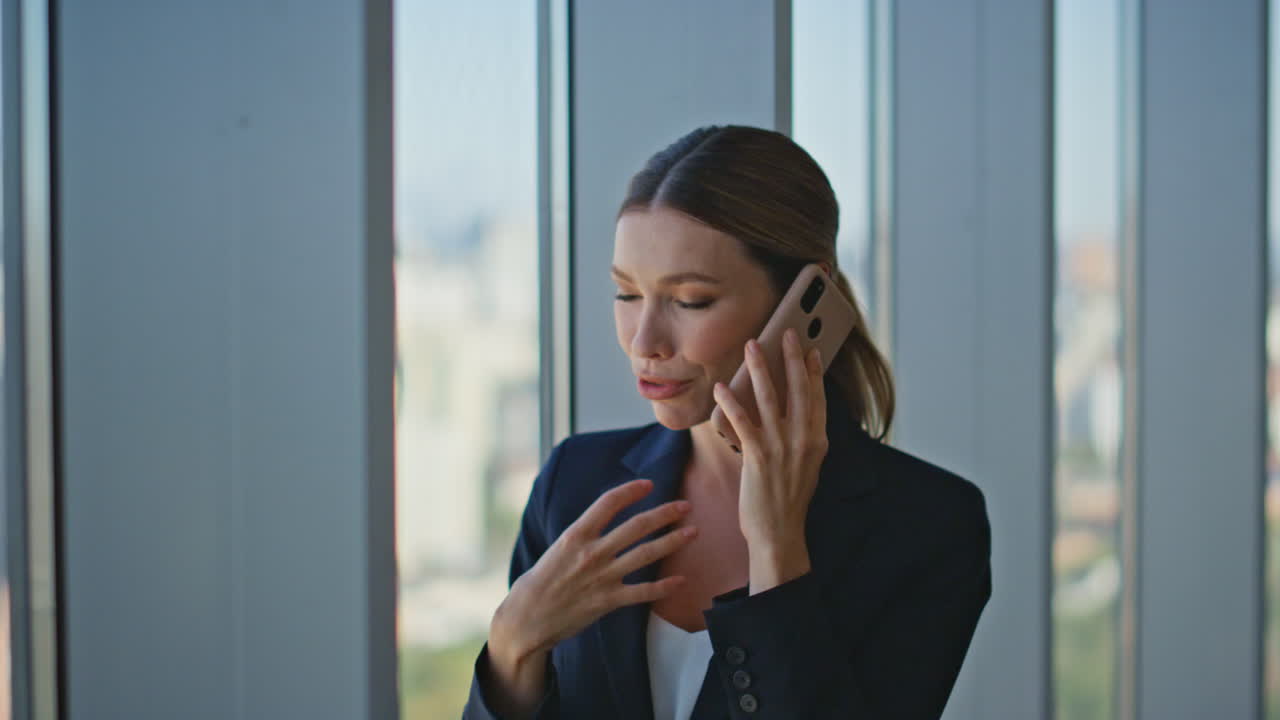 Corporate employee chatting mobile phone closeup. Happy woman sharing good news