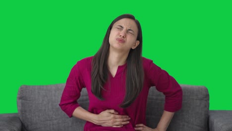 sick indian woman suffering from stomach pain green screen