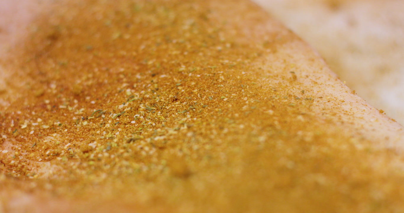 Close up seasoning brisket before smoking in commercial kitchen