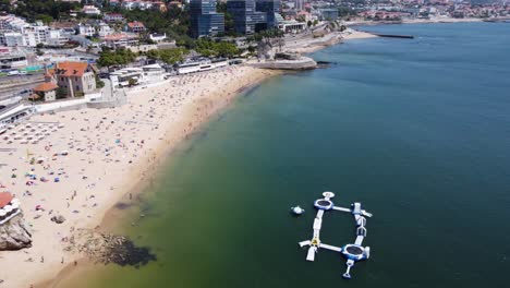 aerial orbiting shot of the biggest beach in cascais, portugal