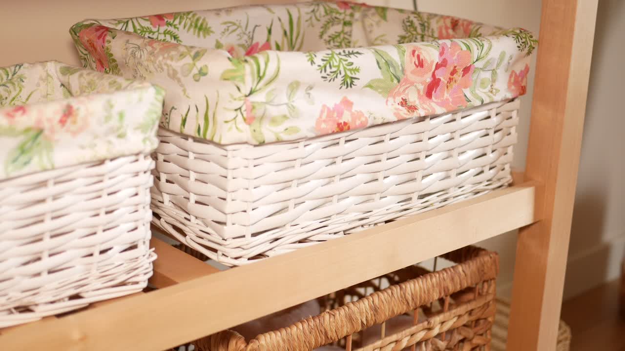 White Wicker Baskets with Floral Liners on Wooden Shelves