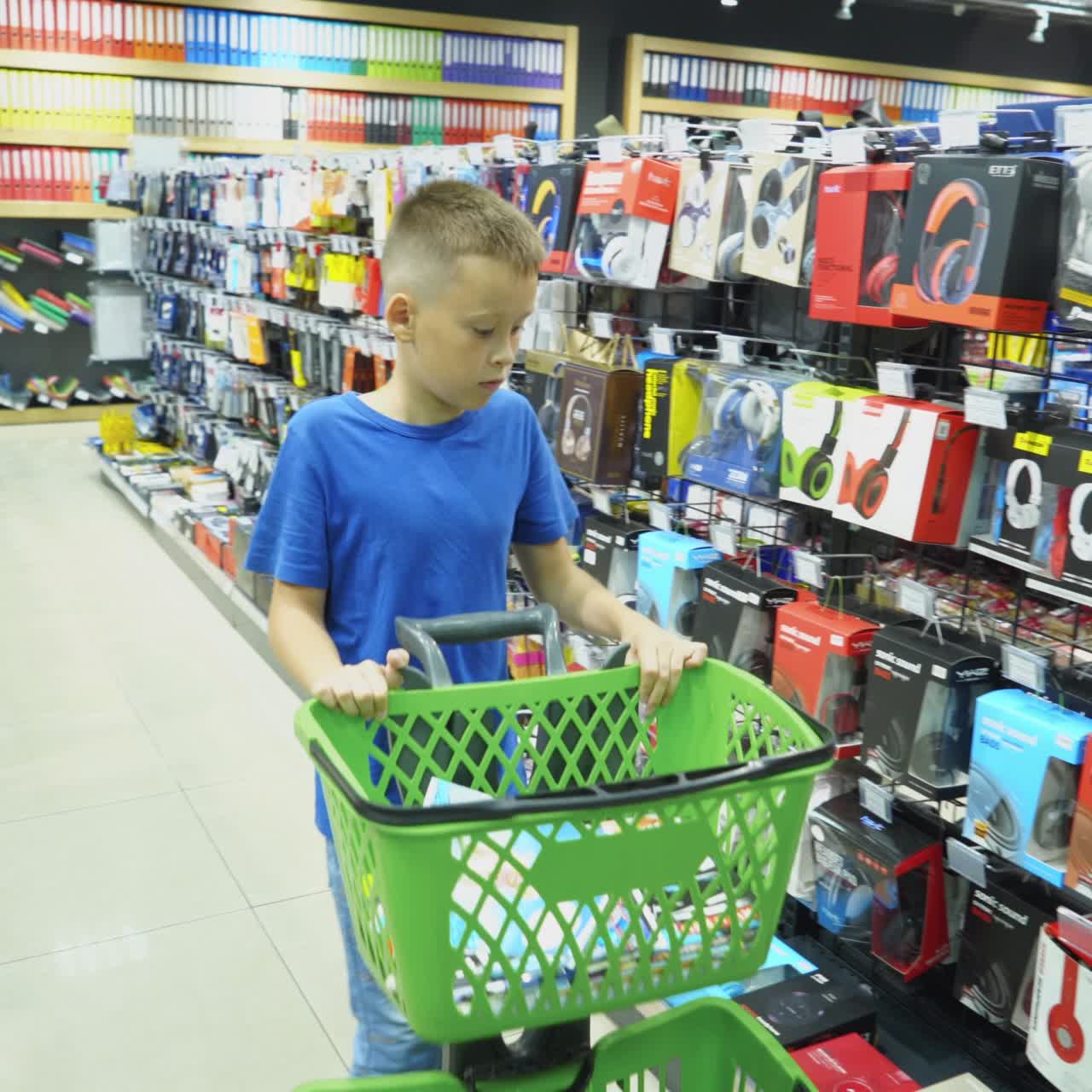 VINNITSA, UKRAINE - AUGUST 20, 2018: Back to School. Boy choosing school stationery at the supermarket.