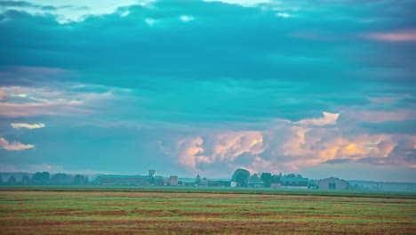 clouds billowing in the sky over rural farm and houses on a foggy morning in autumn