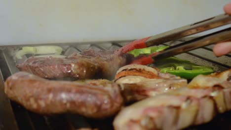 Cooking-delicious-barbecue-with-pork,-sausage,-meet-and-vegetables