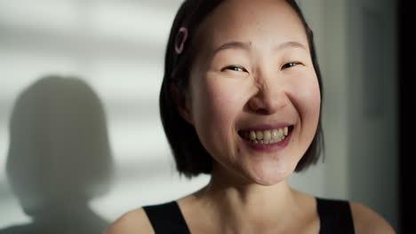 asian woman looking at the camera making an online video call talking, speaking with smiling face communicate with a friend, posing