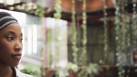 Half-portrait-of-happy-african-american-casual-businesswoman-in-foyer,-copy-space,-slow-motion