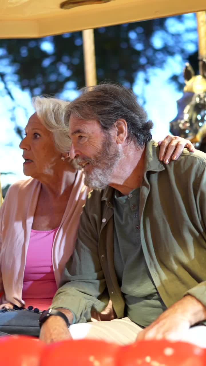 Senior Couple Enjoying a Carousel Ride