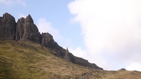 looking up at the black cliff face of old man of storr on isle of skye, highlands of scotland