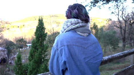 traveler contemplating views of the forest and mountains during the binding