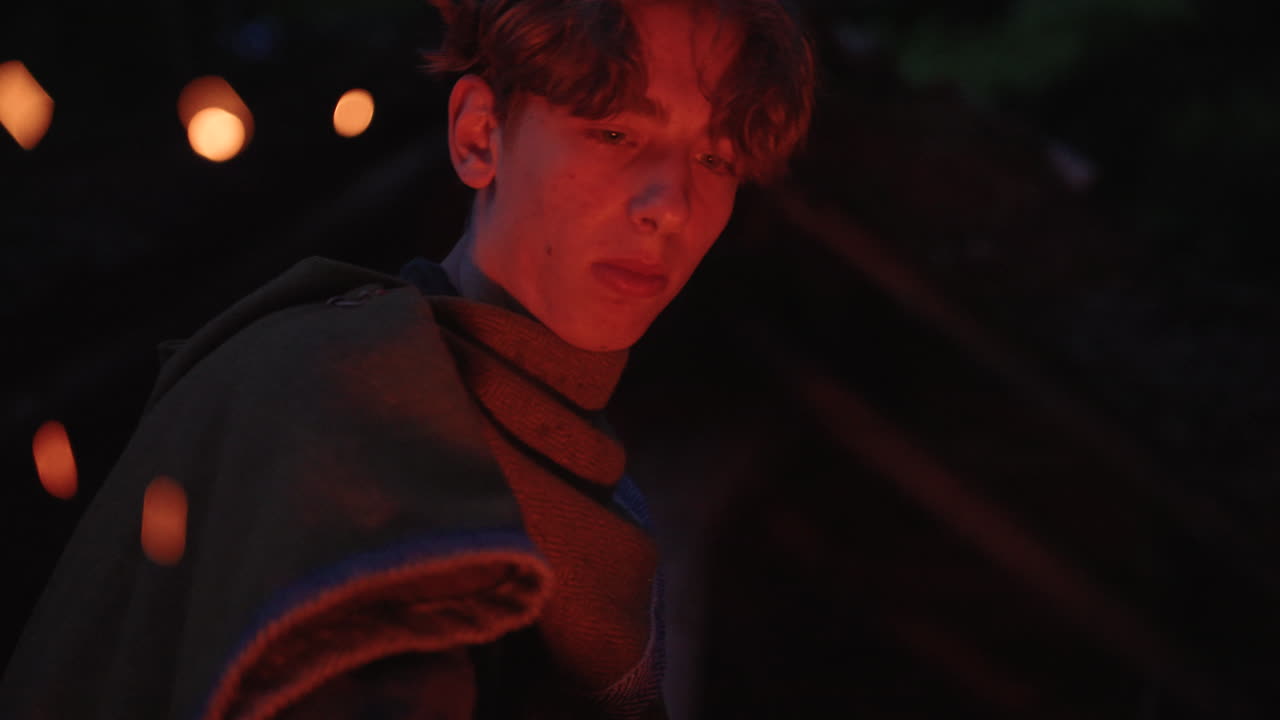 Teenager in Medieval Costume by Fire