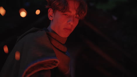 teenager in medieval costume by fire