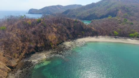 Sliding-along-a-rough-peninsula-on-an-abandoned-island-near-Costa-Rica-adjacent-to-a-beautiful-tropical-beach