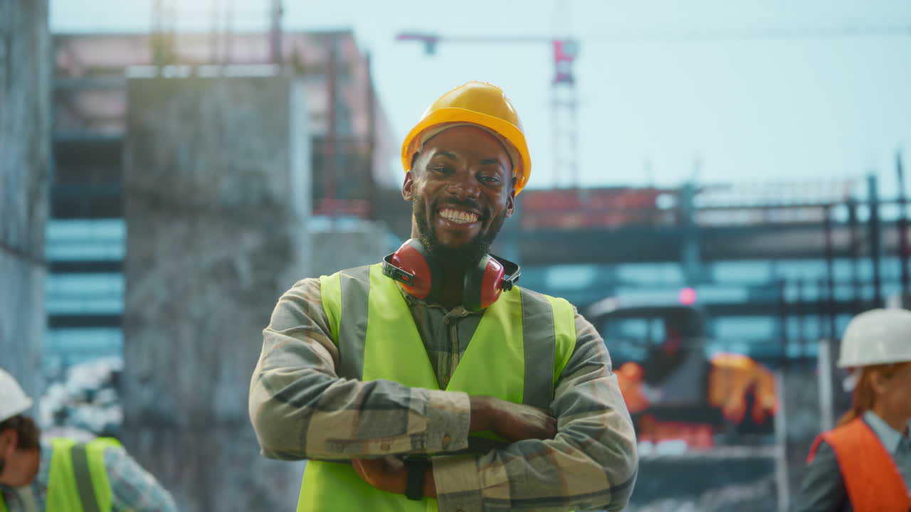 Happy Construction Worker Smiling on a Building Site with Team