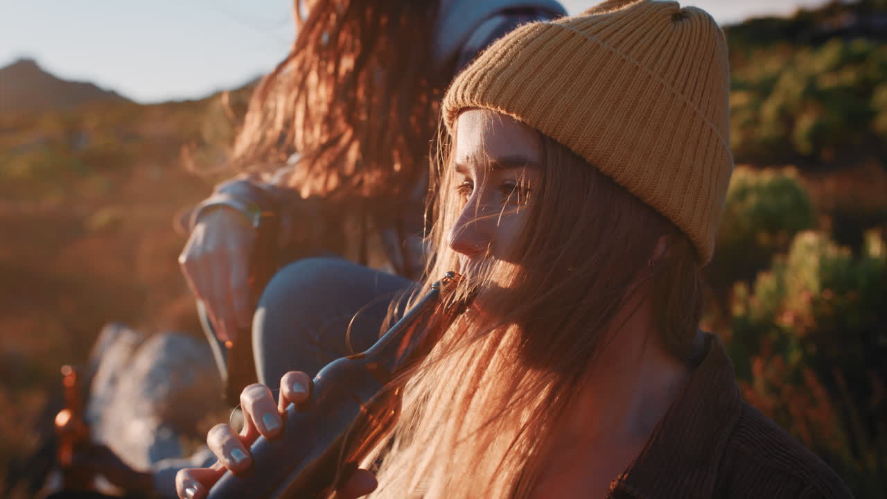 группа друзей пьют вместе, гуляют в красивой сельской местности, наслаждаются закатом солнца в расслабленном летнем отдыхе.