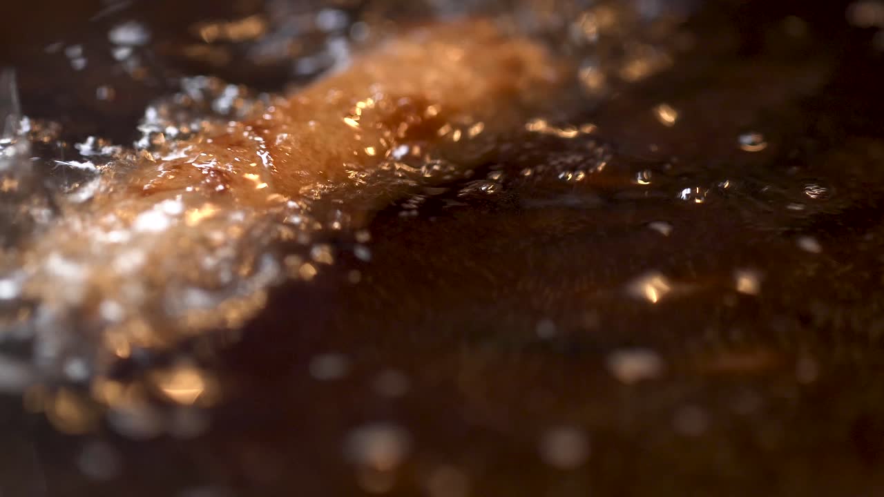 4K macro close up of woman's hands breaking an egg into a bowl