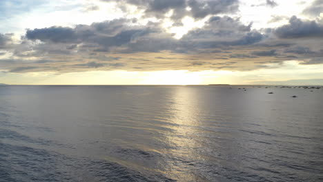 drone timelapse, hyperlapse from the sunset in the philippines showing moving clouds, waves, boats and the sky, aerial