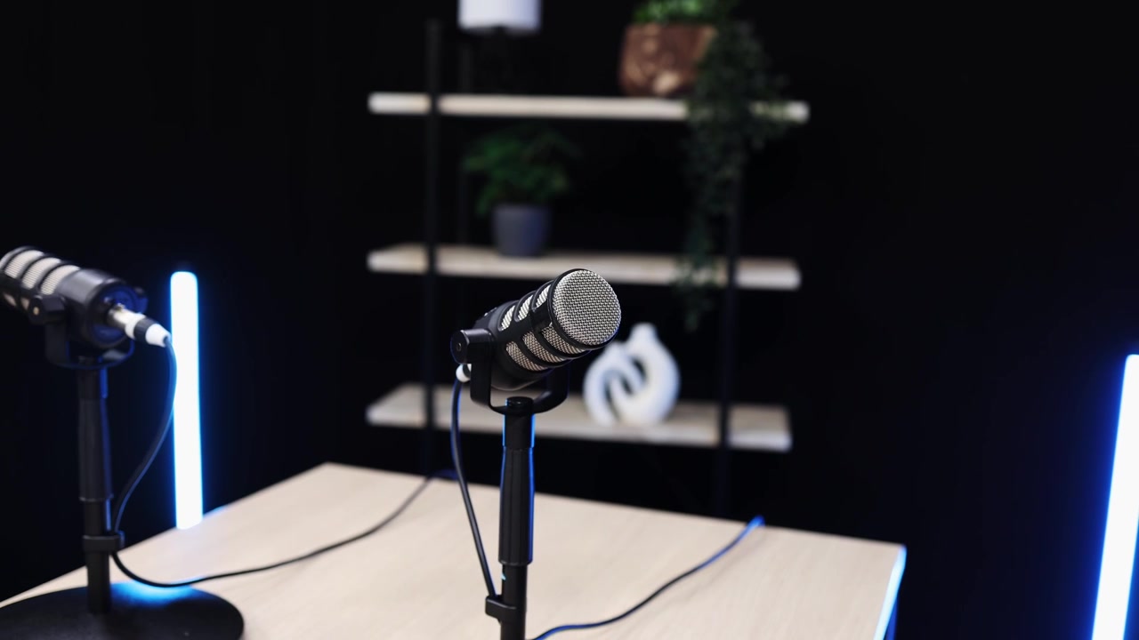 Modern Podcast Studio Setup with Two Microphones and Blue Lights