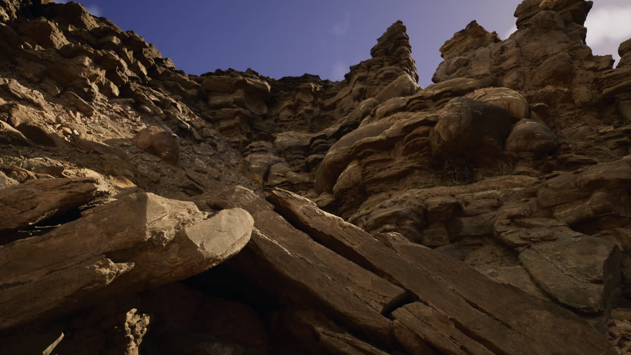 Rock formations rise dramatically under a clear sky in a natural landscape