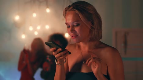 Woman at a party using a phone